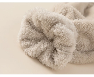 Detailed macro view of soft white sherpa fleece lining on warm winter pajama set