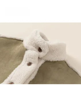 Detail of winter kids jacket collar featuring olive suede and cream sherpa lining with buttons