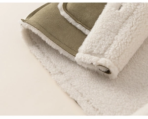 Detail of army green faux suede jacket with thick cream shearling lining and stitching