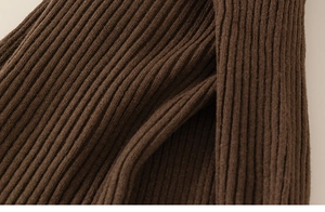 Close-up of thick dark brown ribbed knit fabric showing soft texture and elastic weave