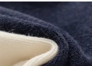 Detailed macro view of the soft navy blue and cream knit fabric with a warm dual-layer texture