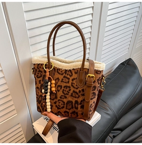 Vue détaillée du sac cabas léopard avec garniture en fausse fourrure blanche et breloque