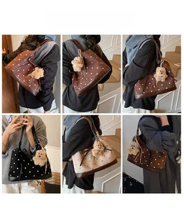 Polka dot tote bag detail featuring plush bear charm and versatile shoulder strap styles
