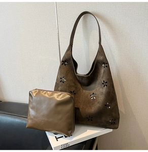 Detail view of large brown suede hobo tote bag featuring a matching inner zipper pouch