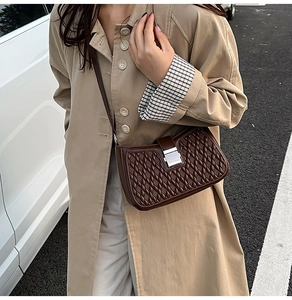 Close-up of dark brown woven texture shoulder bag with silver square metal buckle