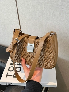 Brown woven pattern crescent bag with silver lock and adjustable shoulder strap