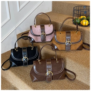 Detail of vintage saddle bags in four colors with horseshoe buckles and matte finish
