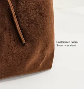 Close-up of premium brown matte suede texture with durable scratch-resistant stitching