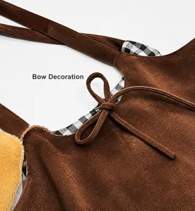 Detail of vintage brown suede bag featuring a bow tie and black white checkered lining