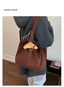 Brown faux suede tote bag with a croissant plush charm and black-white checkered lining