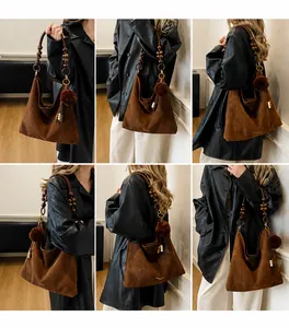 Detailed view of brown suede tote bag with vintage wood bead strap and soft plush ball charm