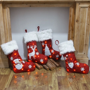 Set of 4 LED lighted Christmas stockings with snowman and reindeer embroidery on rustic wood