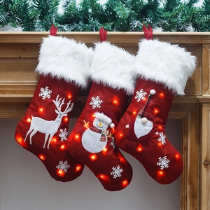 Three-piece set of lighted Christmas stockings with LED gnome, snowman and reindeer designs