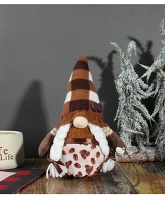 Detail of coffee gnome plush with knitted plaid hat and braided hair on wooden table