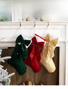 Close-up of sequin Christmas stockings with bows and faux fur trim for festive decor