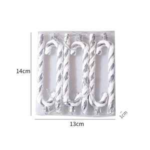 Detailed view of six white and silver glitter candy cane ornaments in clear packaging