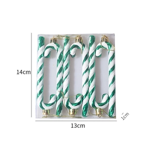 Close-up of 6 candy cane ornaments with green and white glitter swirls in packaging