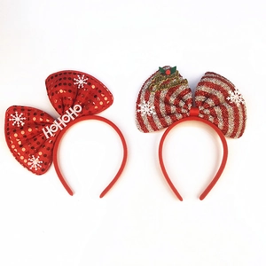 Close-up of festive Christmas headbands with HOHOHO sequins and red striped glitter bows