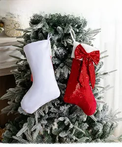 Detail view of red sequin Christmas stocking and white plush variant hanging on tree