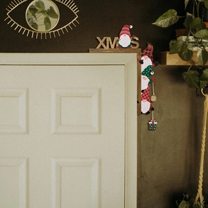 Wooden XMAS gnome door frame decoration with festive red and green gnome figures