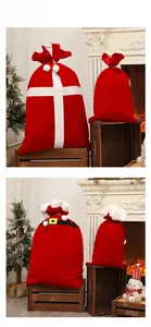 Detail of red velvet Christmas Santa sacks with plush drawstring and gold belt buckle design