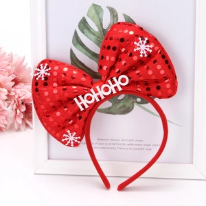 Detail of red sequined Christmas headband featuring a HoHoHo white lettering and snowflakes