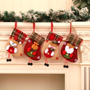 Set of 4 Christmas stockings with festive 3D characters hanging on a white fireplace