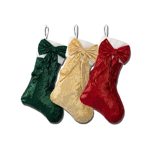 Set of three sequined Christmas stockings in green, gold, and red with large bows