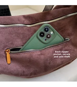 Detail of the hidden back zipper pocket on a brown suede bag for secure storage