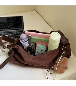 Detail view of coffee suede bag interior showing large capacity for laptop and daily items