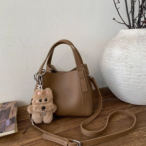 Deep khaki bucket bag with lychee grain texture and cute plush bear charm for women