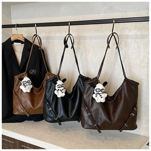 Detailed view of three large Hobo tote bags in brown and black with plush dog charms