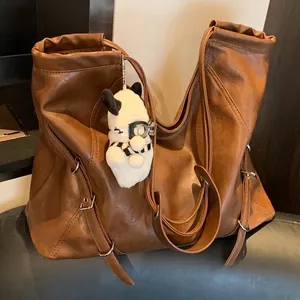 Retro brown large capacity tote bag with adjustable buckle straps and soft leather texture