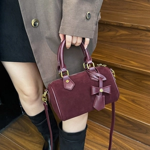 Elegant burgundy pillow handbag with bow decoration and gold metal zipper for women