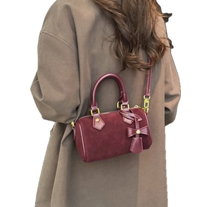 Chic burgundy Boston pillow bag in suede and smooth leather for daily commuting