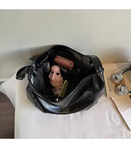 Interior view of black glossy tote bag showing spacious capacity for daily essentials