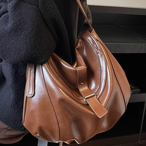 Vintage brown hobo shoulder bag with crescent shape and adjustable leather strap