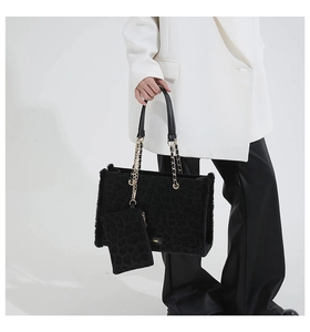 Detail of plush leopard print tote bag with gold chain strap and matching coin purse