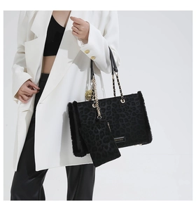 Close-up of leopard print tote bag with faux fur trim and matching coin purse detail