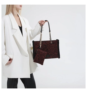 Detail of leopard print tote bag with plush faux fur trim and gold metal chain strap