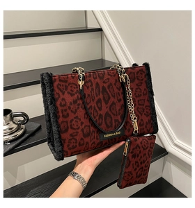 Detail of red leopard print tote with faux fur trim, chain strap and matching pouch