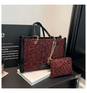 Detail of burgundy leopard print tote bag with faux fur trim and gold chain strap