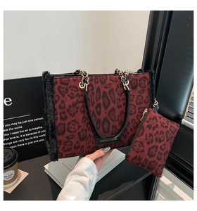 Detail of red leopard print tote bag featuring plush trim and golden chain strap detail