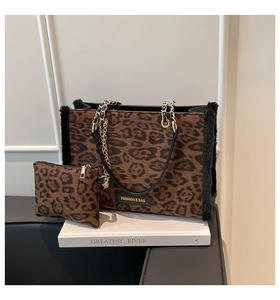 Detail of leopard print tote bag set with plush texture and gold chain shoulder strap