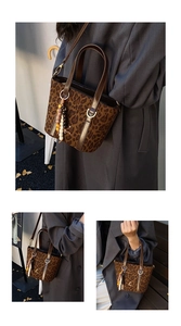 Detail of leopard print bucket bag with beaded accessory and adjustable strap