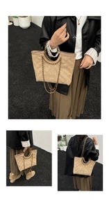 Detail of beige quilted tote bag with classic diamond pattern and gold chain strap