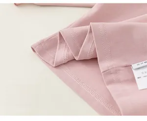 Macro shot of high-quality cotton knit fabric with precision double-stitch hem detail