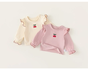 Close-up of baby long sleeve T-shirt with cherry embroidery and ruffled collar details