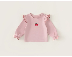 Detailed view of pink cotton baby t-shirt featuring cherry embroidery and ruffle trim