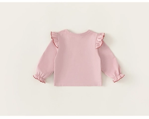 Detailed view of pink long sleeve cotton tee with ruffled lace trim and red stitching edges